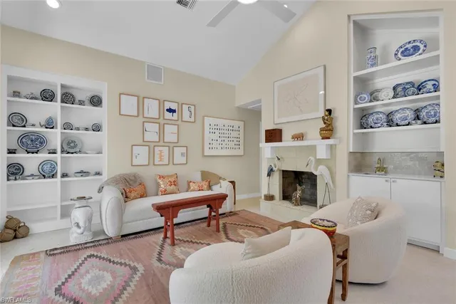 a living room with furniture and a fireplace
