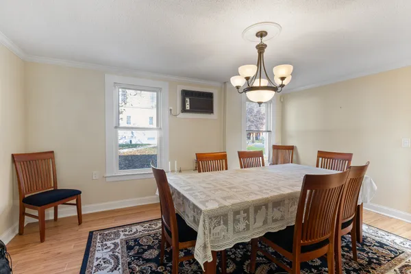 a view of a dining room with furniture window and wooden floor