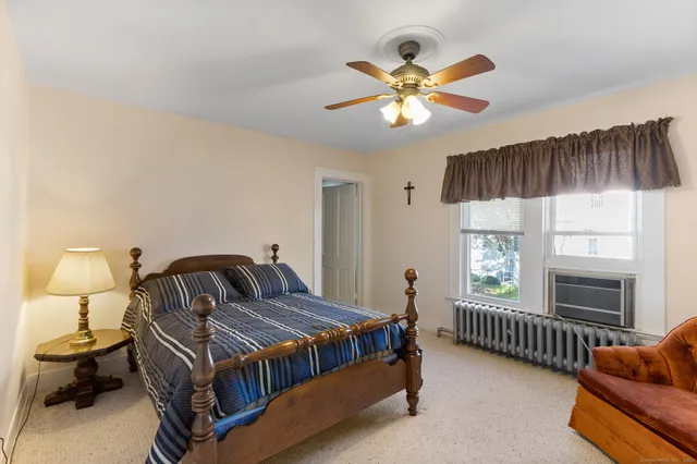 a bedroom with a bed and ceiling fan