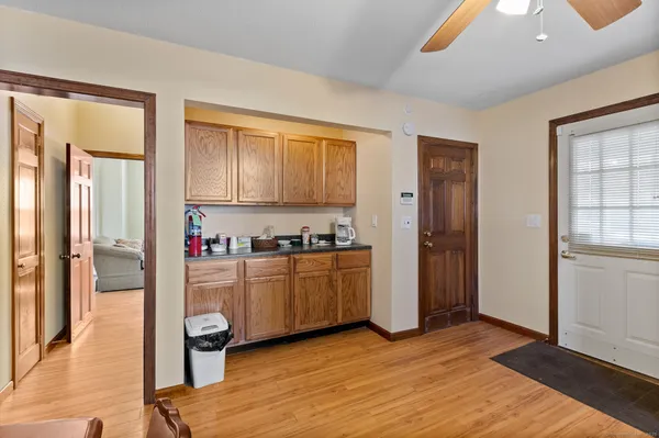 a kitchen with granite countertop a refrigerator and wooden cabinets