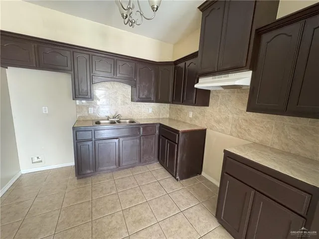 a kitchen with a sink a stove and a refrigerator