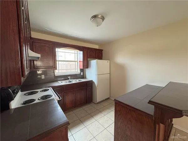 a kitchen with refrigerator and window