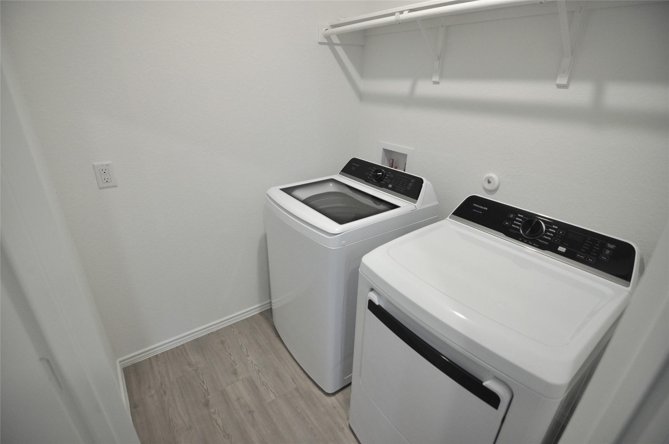 1537 Chapel Ranch Road Georgetown, TX 78628 - Photo 12 of 25 Laundry room featuring light wood finished floors and washing machine and dryer