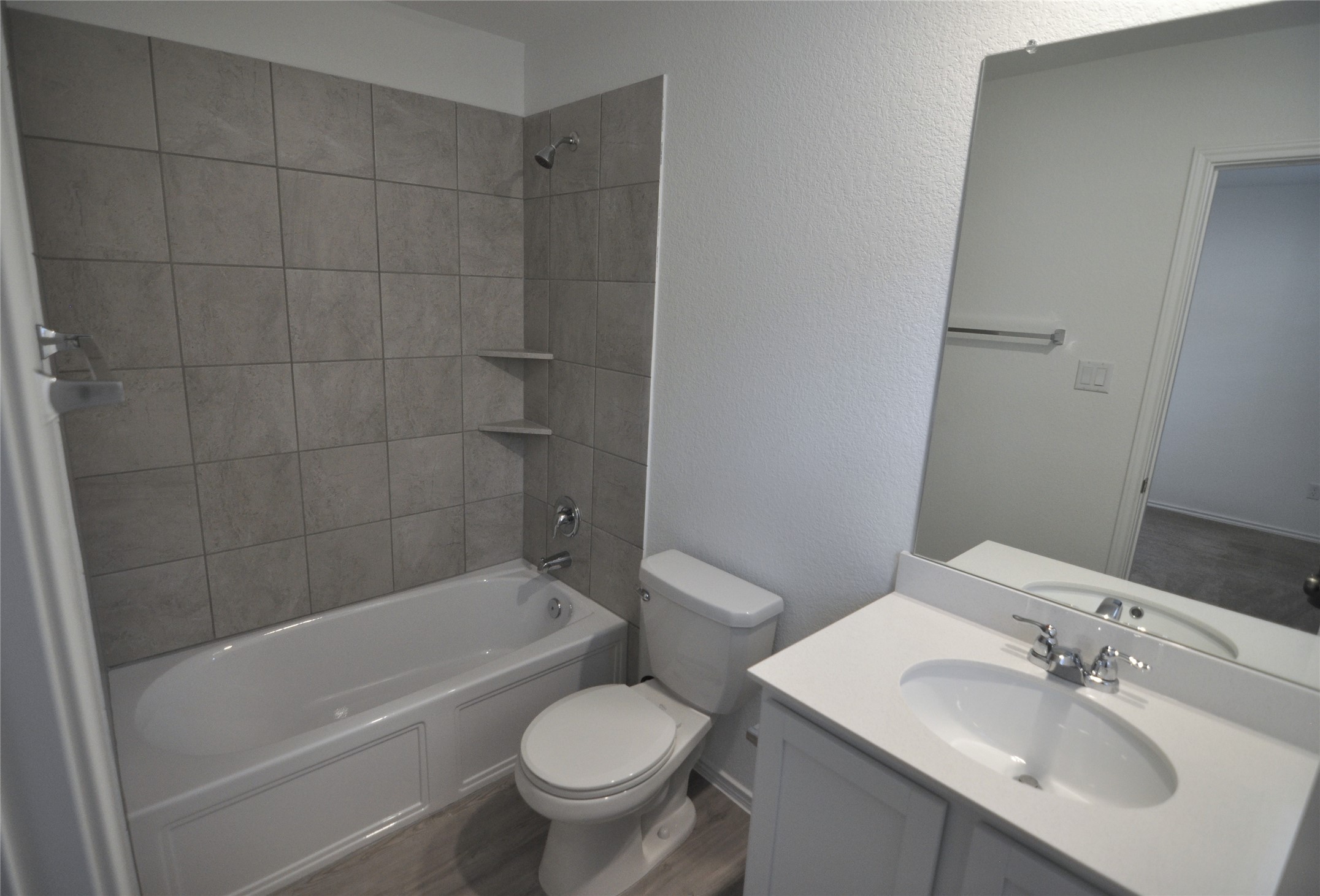 1537 Chapel Ranch Road Georgetown, TX 78628 - Photo 14 of 25 Full bath featuring vanity, shower / tub combination, a textured wall, and dark wood-style floors