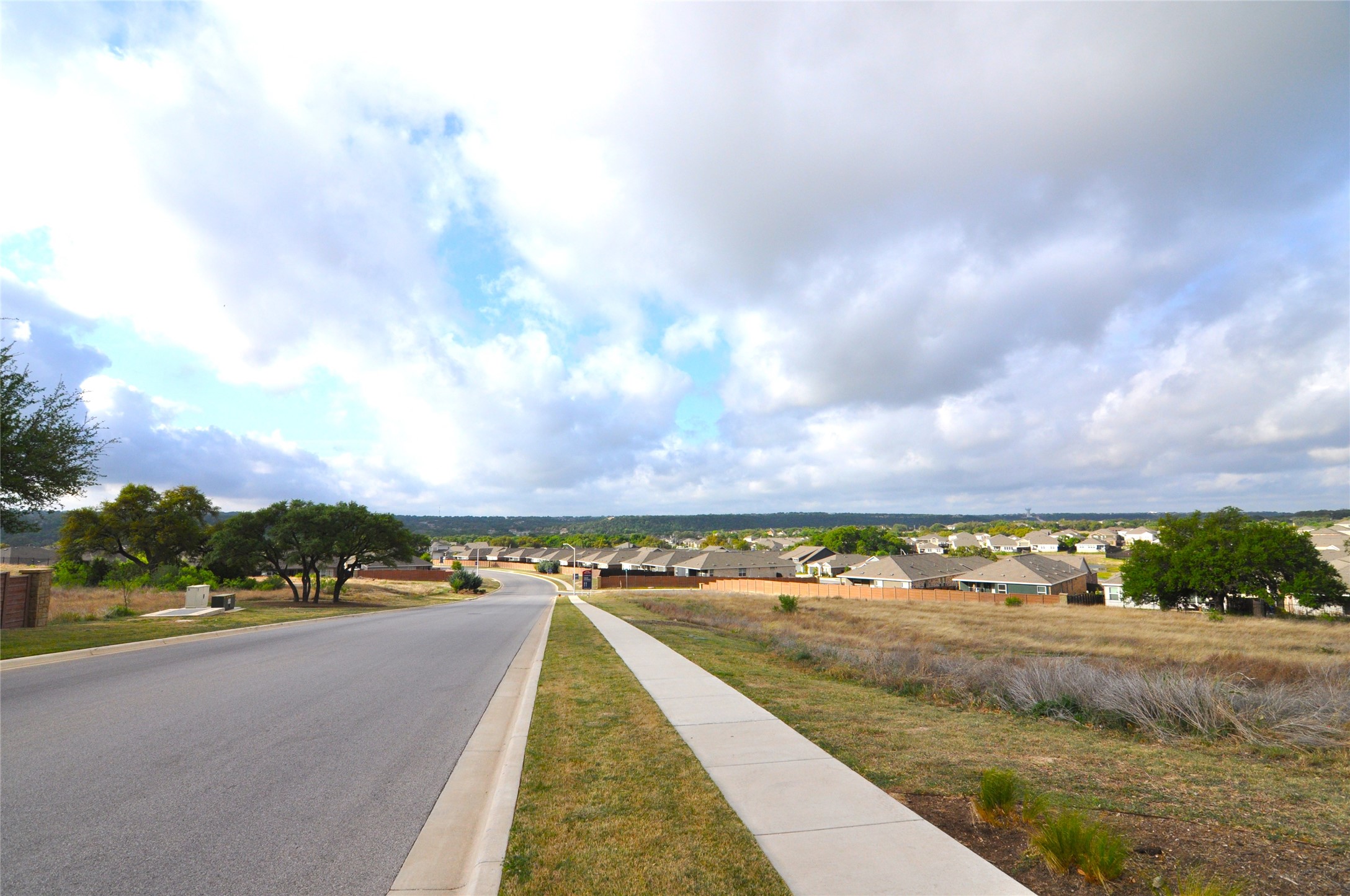 1537 Chapel Ranch Road Georgetown, TX 78628 - Photo 2 of 25 View of asphalt street with sidewalks, a residential view, and curbs