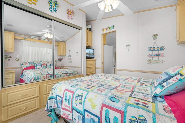 a bedroom with bed and wooden floor