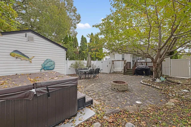 a backyard of a house with fire pit and furniture