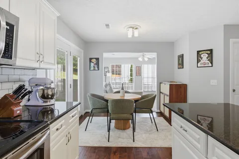 a view of a dining room with furniture and wooden floor