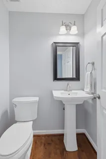 a bathroom with a toilet a sink and mirror