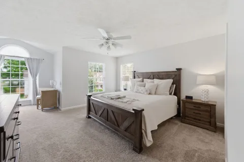 a spacious bedroom with a bed and a couch