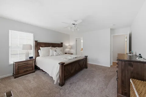 a bedroom with a bed dresser and a window