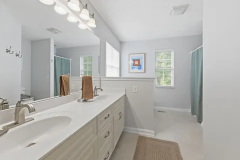 a bathroom with a double vanity sink and a mirror