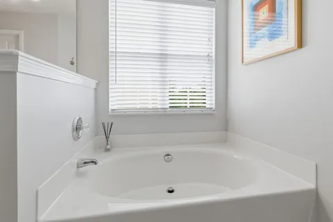 a white bath tub sitting next to a window