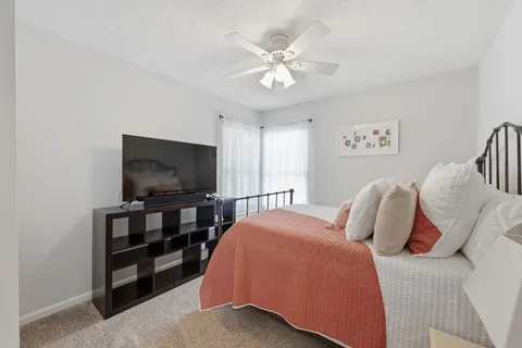 a bedroom with a bed and a flat screen tv