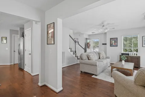a living room with furniture and a wooden floor