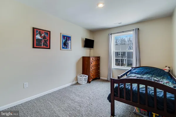 a bedroom with furniture and a window