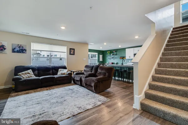 a living room with furniture and stairs