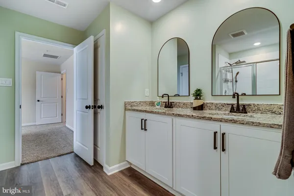 a bathroom with a double vanity sink and mirror