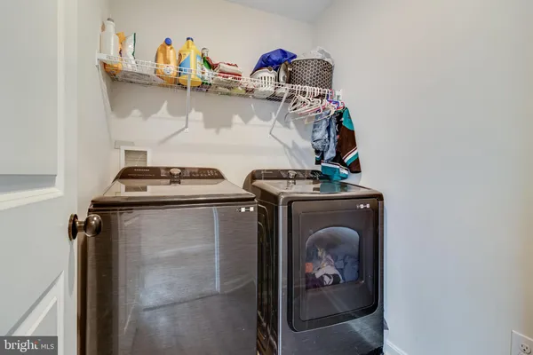 a close view of a storage and utility room with two washing machine