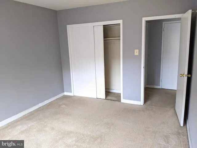 a view of an empty room and closet area