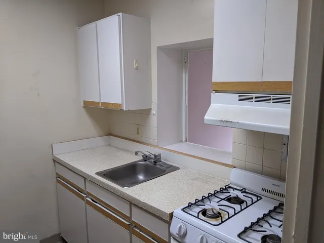 a kitchen with a stove and a sink