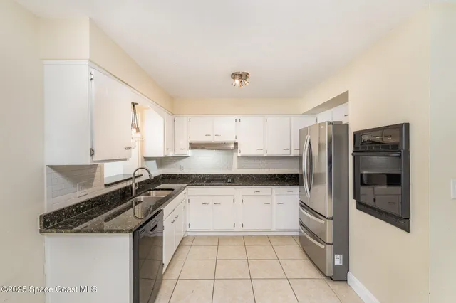 a view of a kitchen with white cabinets