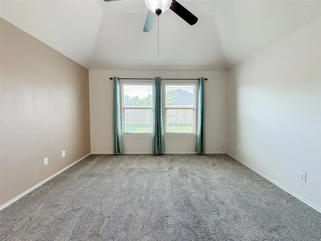 a spacious bathroom with a double vanity sink a mirror and a bathtub