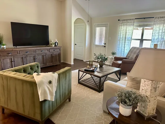 a living room with furniture and a book shelf