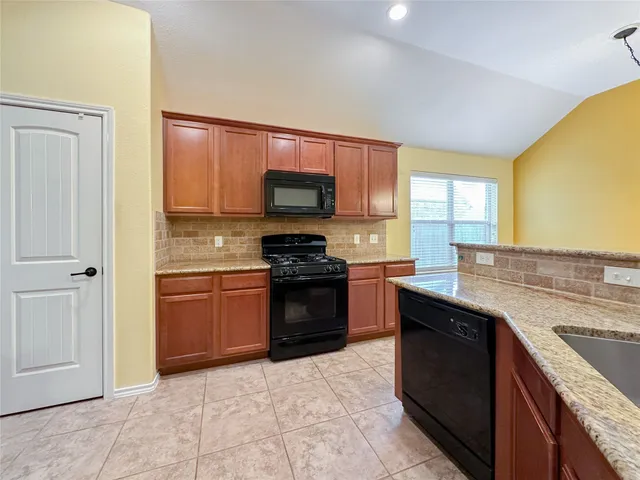 a view of a refrigerator in kitchen and wooden floor