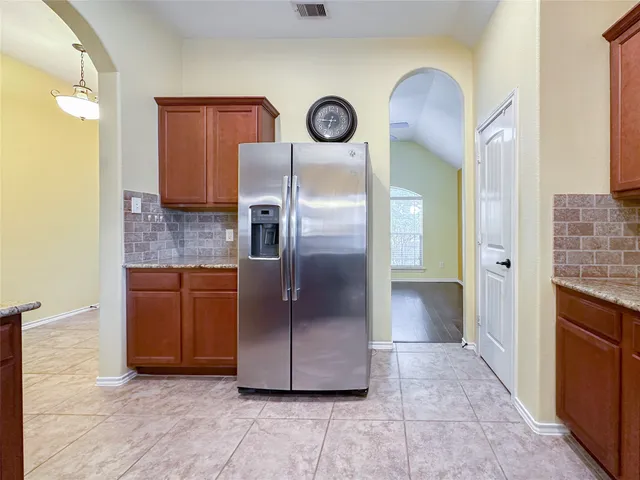 a large kitchen with cabinets and stainless steel appliances