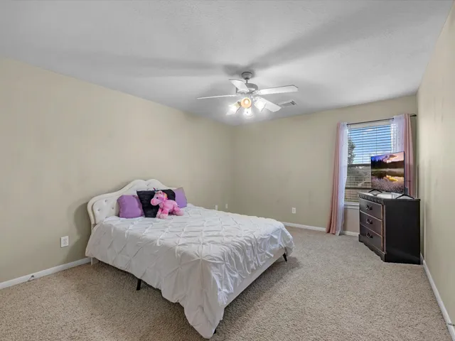 a bedroom with a bed and chandelier