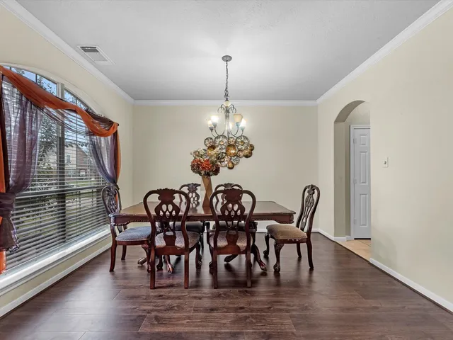 a dining room with furniture window and wooden floor