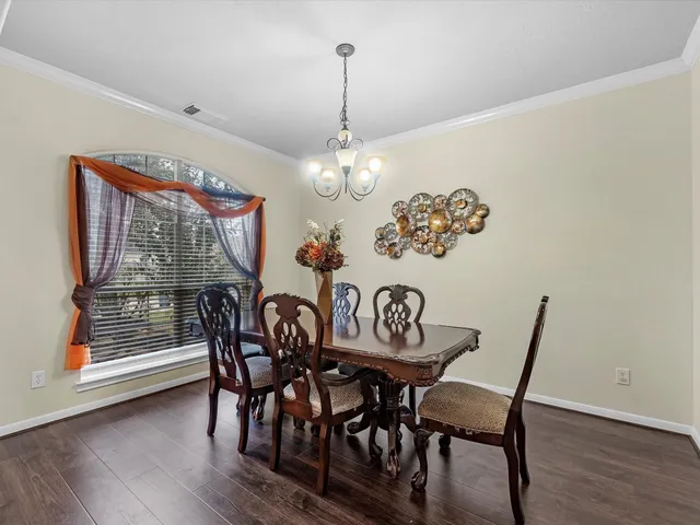 a view of a dining room with furniture large window and wooden floor