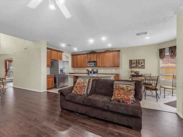a living room with furniture and wooden floor