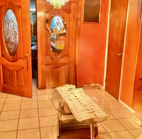 a bedroom with a bed and mirror