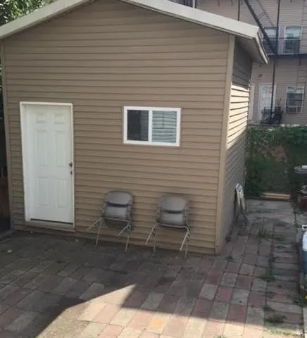 a view of a patio with chairs and potted plants