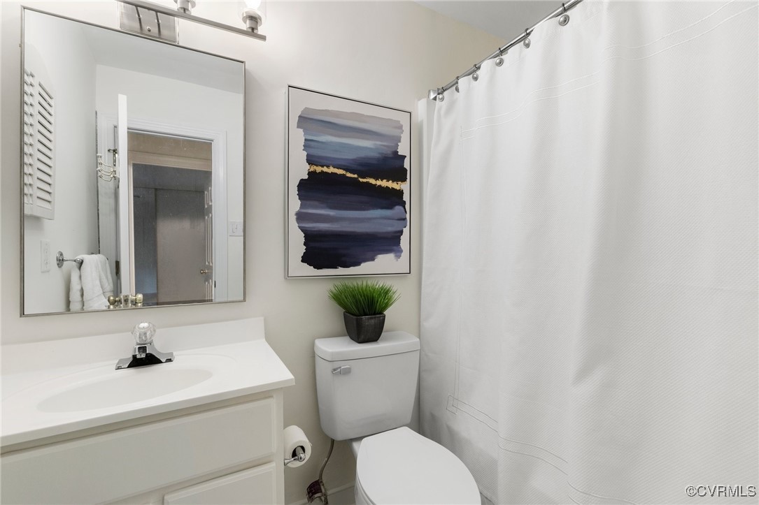 11719 South Briar Patch Drive Midlothian, VA 23113 - Photo 17 of 21 a bathroom with a sink a toilet and a mirror