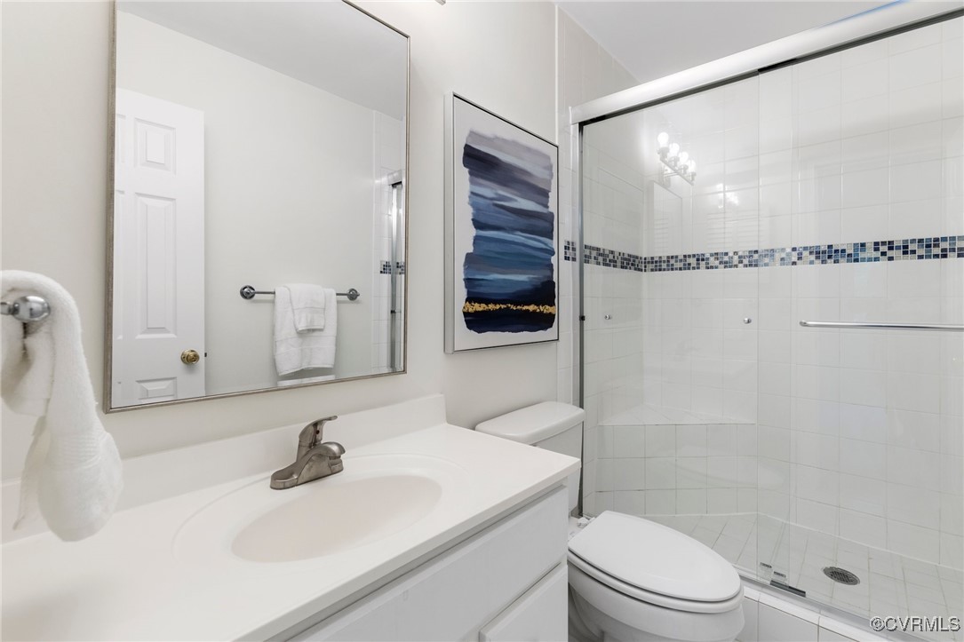 11719 South Briar Patch Drive Midlothian, VA 23113 - Photo 20 of 21 a bathroom with a sink toilet a mirror and shower