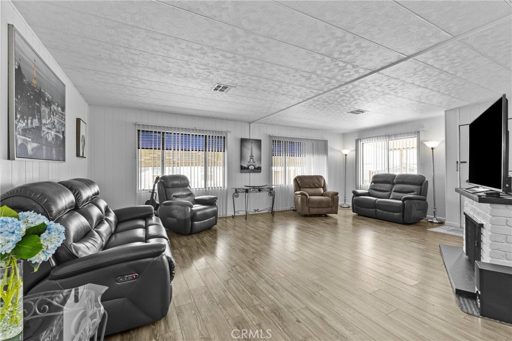 4000 Pierce Street, Unit 132 Riverside, CA 92505 - Photo 11 of 43 a living room with furniture and a flat screen tv