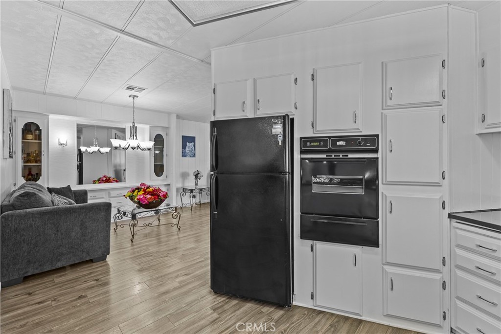 4000 Pierce Street, Unit 132 Riverside, CA 92505 - Photo 13 of 43 a kitchen with refrigerator and cabinets