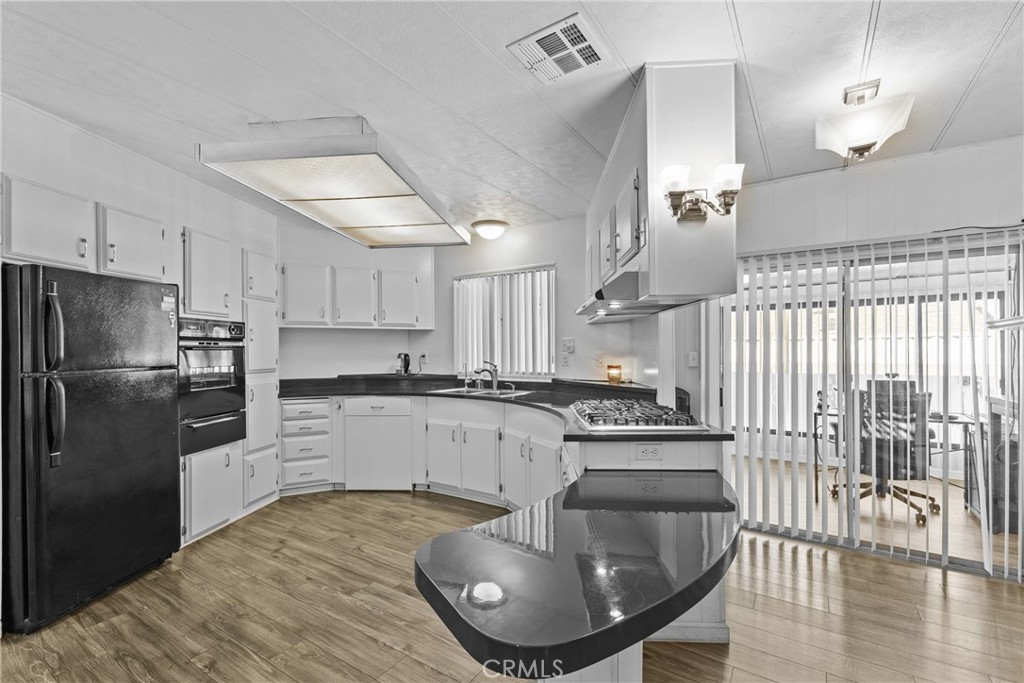 4000 Pierce Street, Unit 132 Riverside, CA 92505 - Photo 15 of 43 a kitchen with stainless steel appliances granite countertop a sink a stove and refrigerator