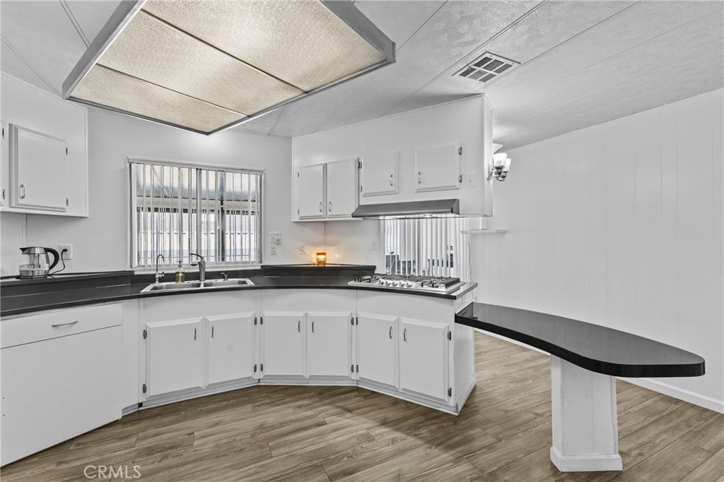 4000 Pierce Street, Unit 132 Riverside, CA 92505 - Photo 17 of 43 a kitchen with granite countertop white cabinets and white appliances