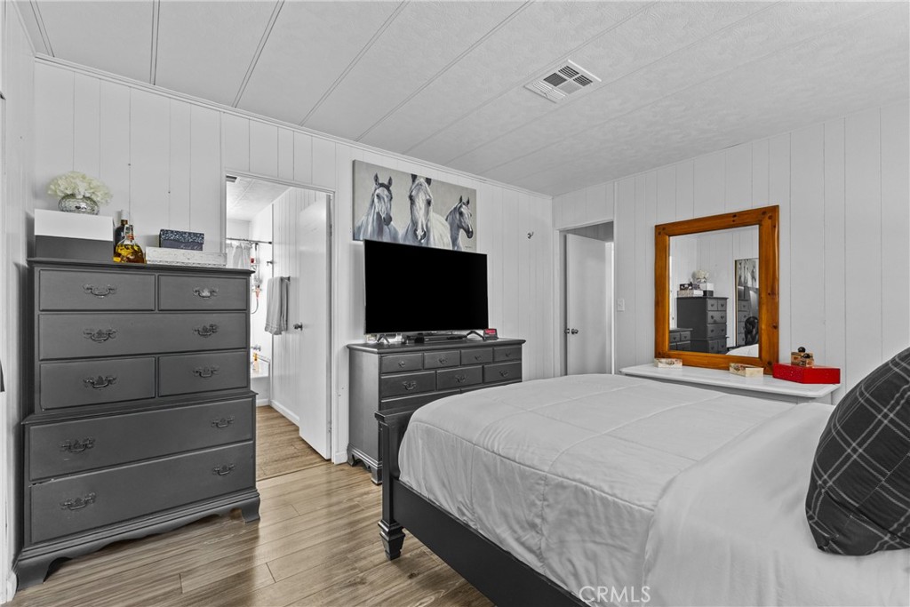 4000 Pierce Street, Unit 132 Riverside, CA 92505 - Photo 25 of 43 a bedroom with a bed and a flat screen tv