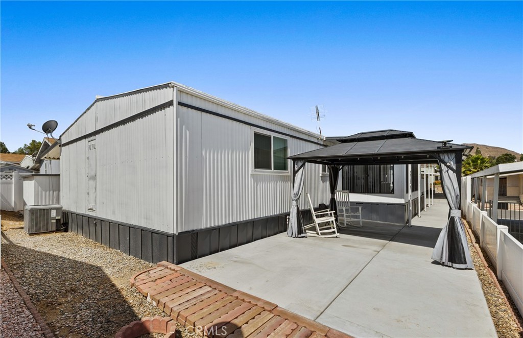 4000 Pierce Street, Unit 132 Riverside, CA 92505 - Photo 30 of 43 a roof deck with table and chairs under an umbrella