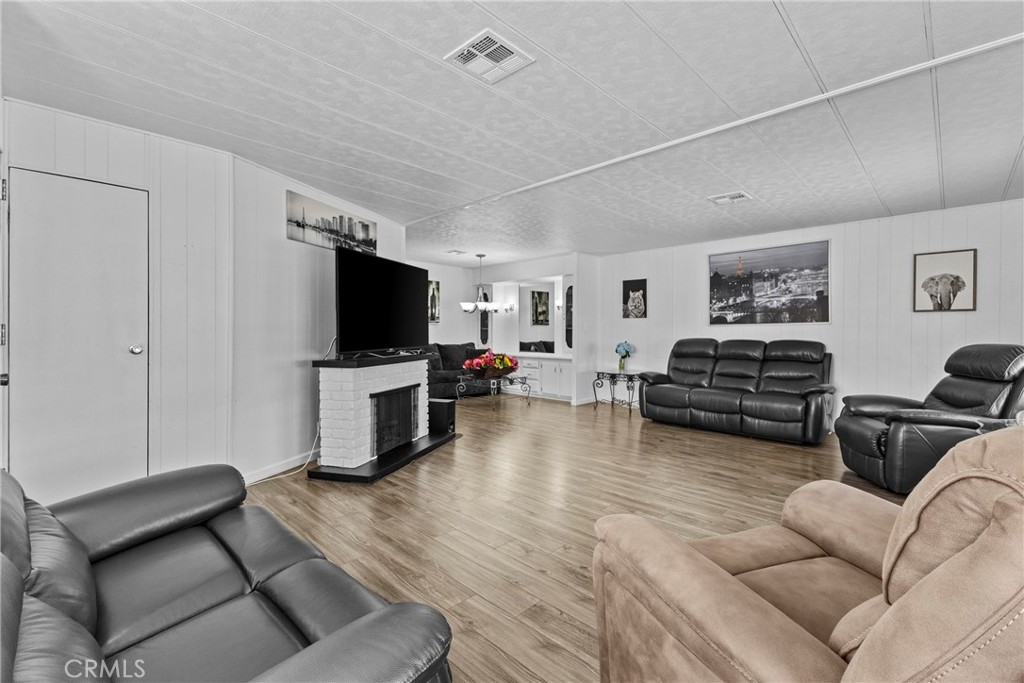4000 Pierce Street, Unit 132 Riverside, CA 92505 - Photo 8 of 43 a living room with furniture and a flat screen tv
