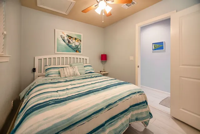 a bedroom with a bed and a painting on the wall