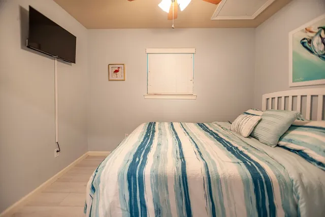 a bedroom with a bed and a flat screen tv