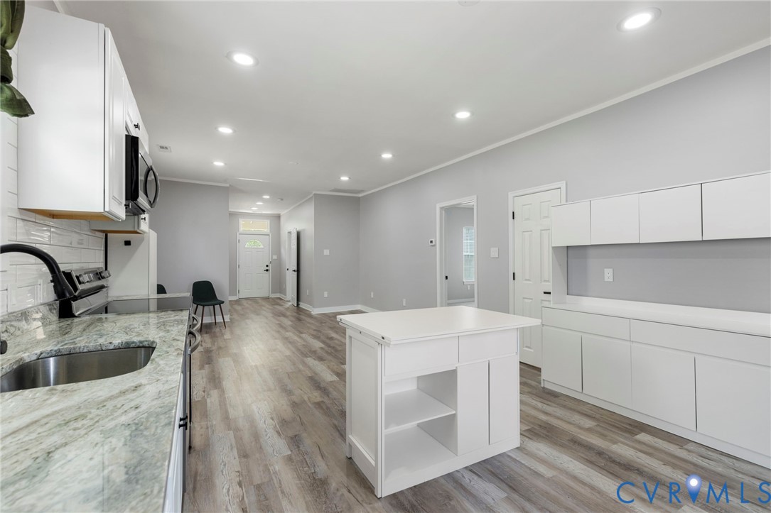 3061 Decatur Street Richmond, VA 23224 - Photo 14 of 23 Kitchen with white cabinetry, crown molding, open