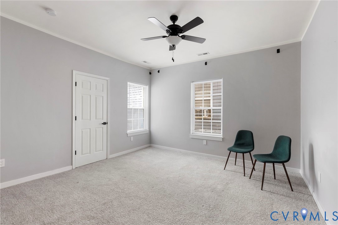 3061 Decatur Street Richmond, VA 23224 - Photo 16 of 23 Living area with crown molding, light carpet, and