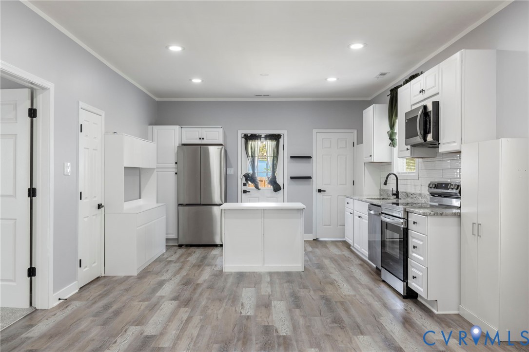 3061 Decatur Street Richmond, VA 23224 - Photo 8 of 23 Kitchen with white cabinets, appliances with stain